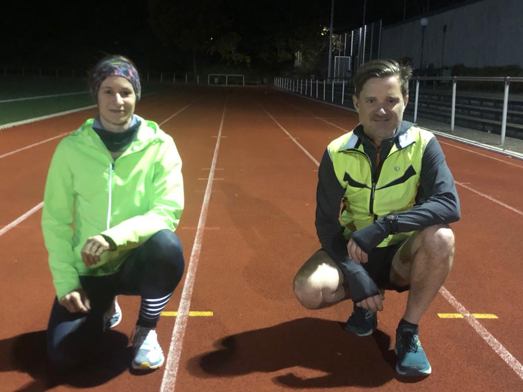 Titelbild Syker LAUFzeit: Sabine und Joachim hocken auf der Laufbahn